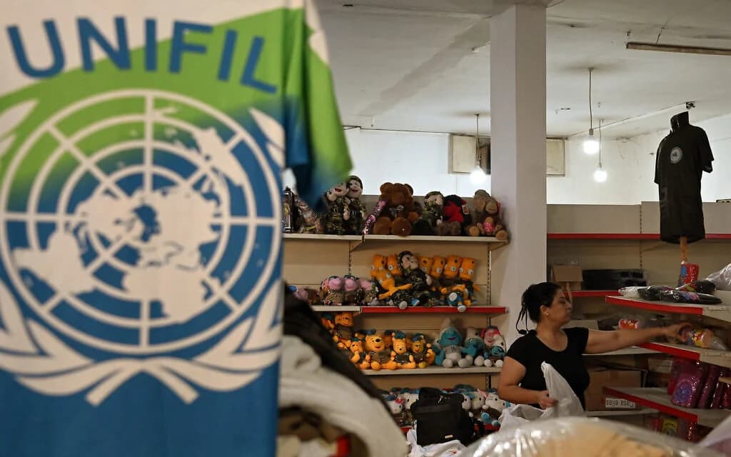 A worker arranges merchandise made for UNIFIL personnel at a factory showroom in Ibl al-Saqi